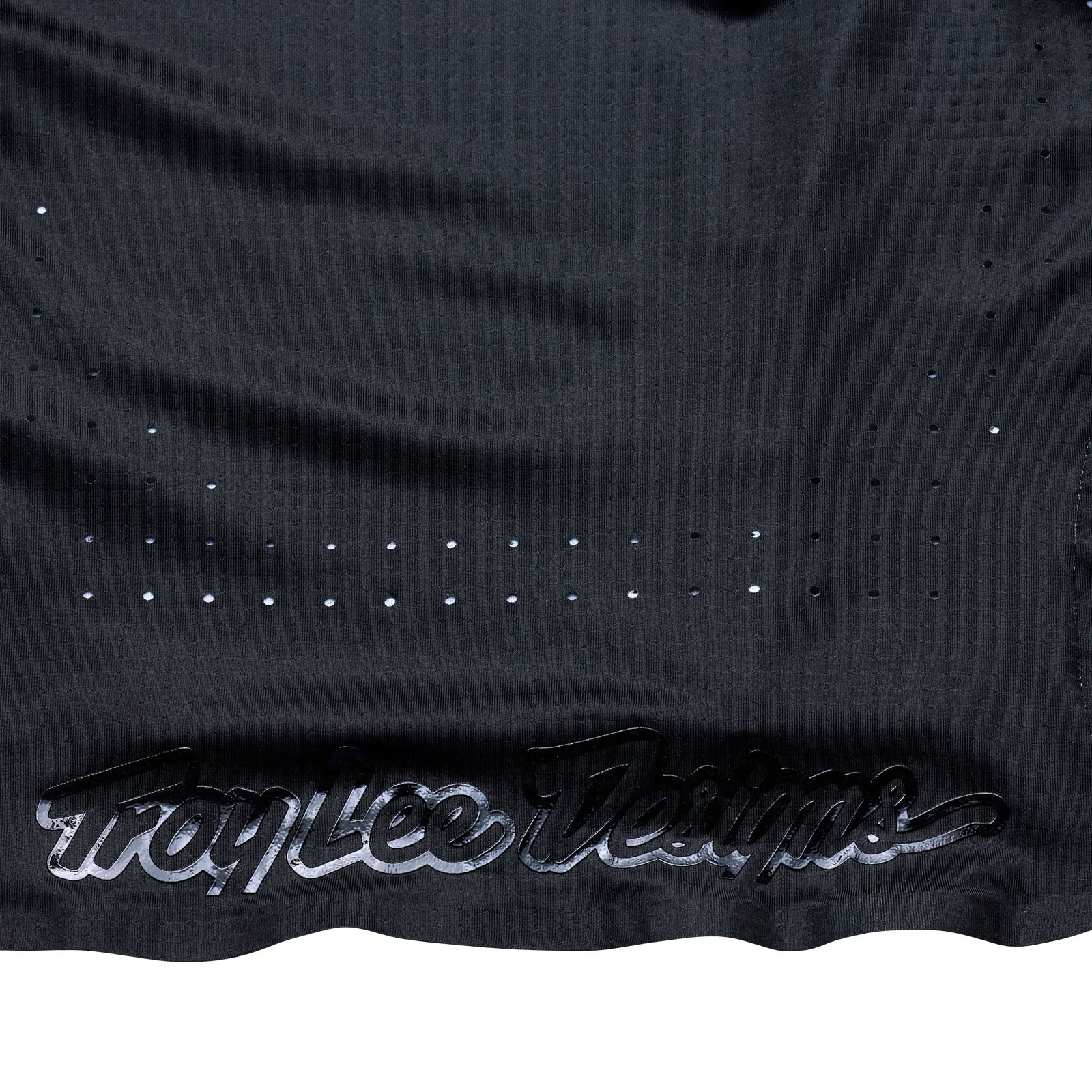 Black sports jersey with 'Troy Lee Designs' branding on a white background