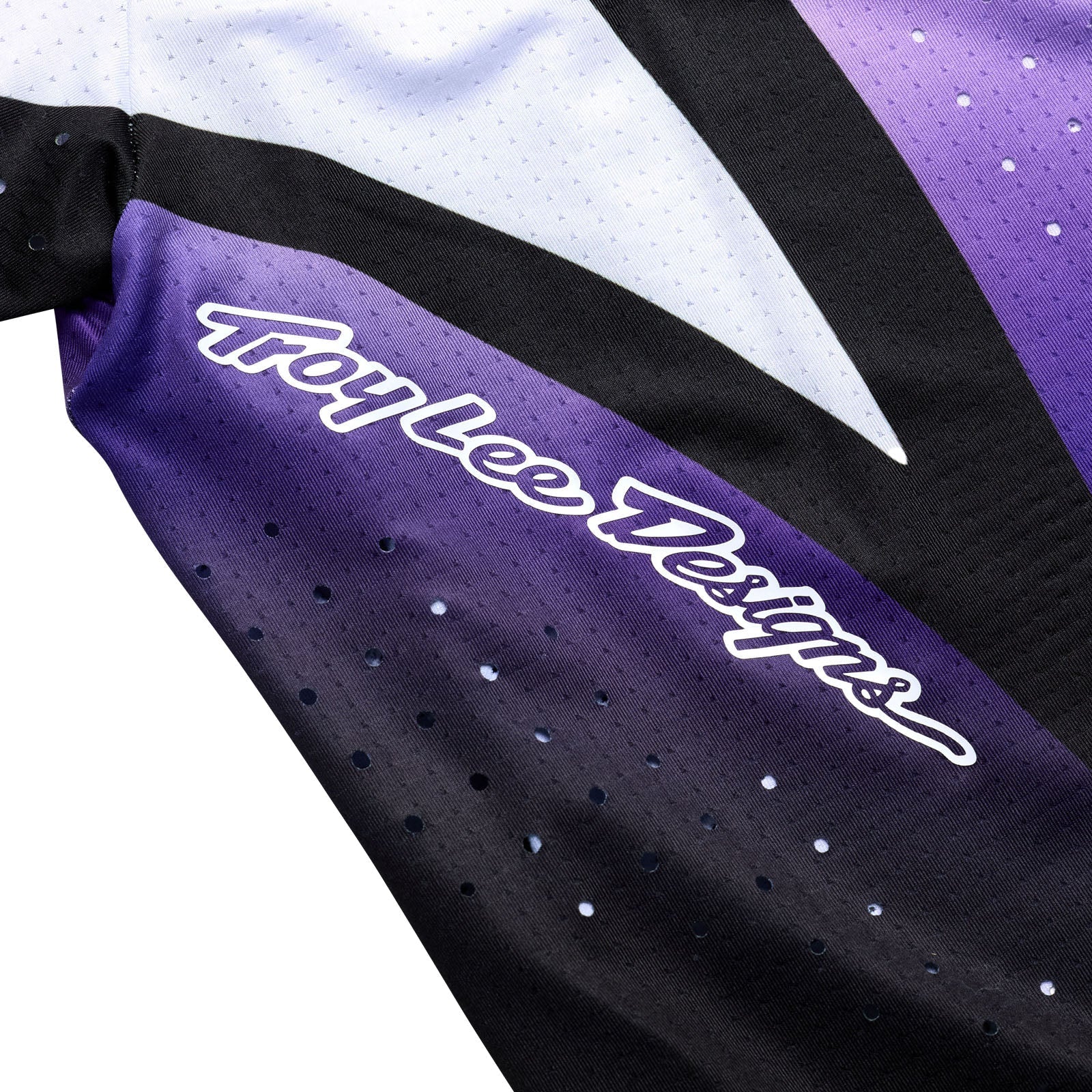 Close-up of a Troy Lee Designs jersey with purple and black colors.