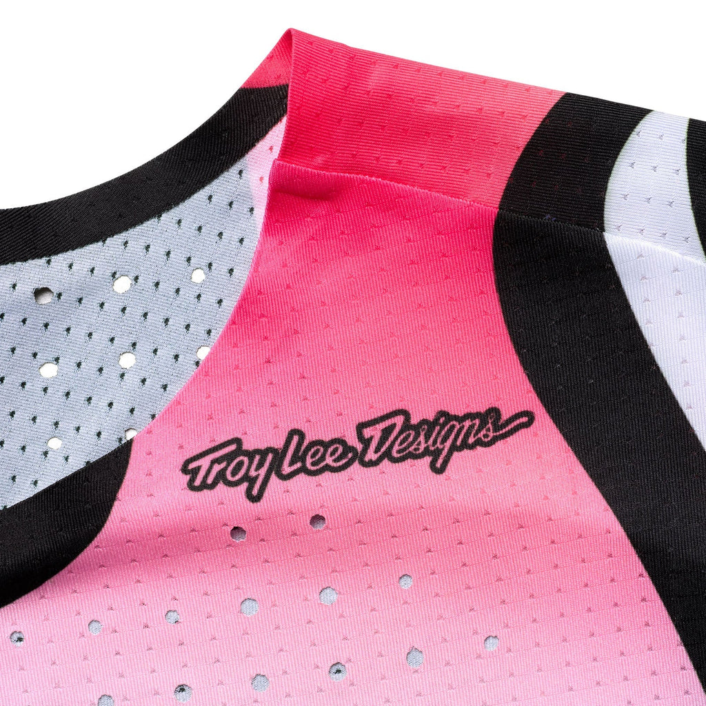 Pink sports jersey with black and white accents and 'Troy Lee Designs' logo.