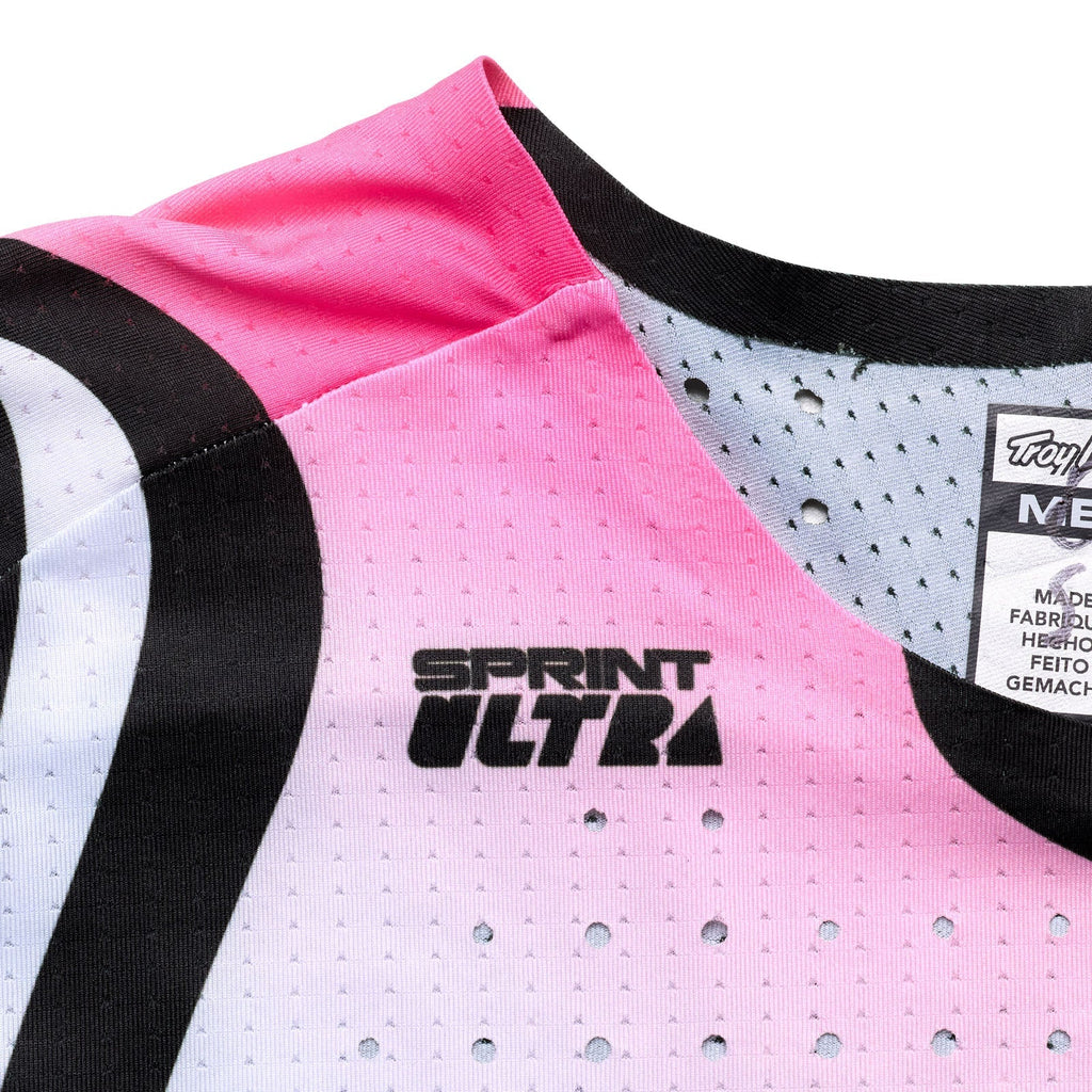Close-up of a pink athletic shirt with 'Sprint Ultra' text and brand label.