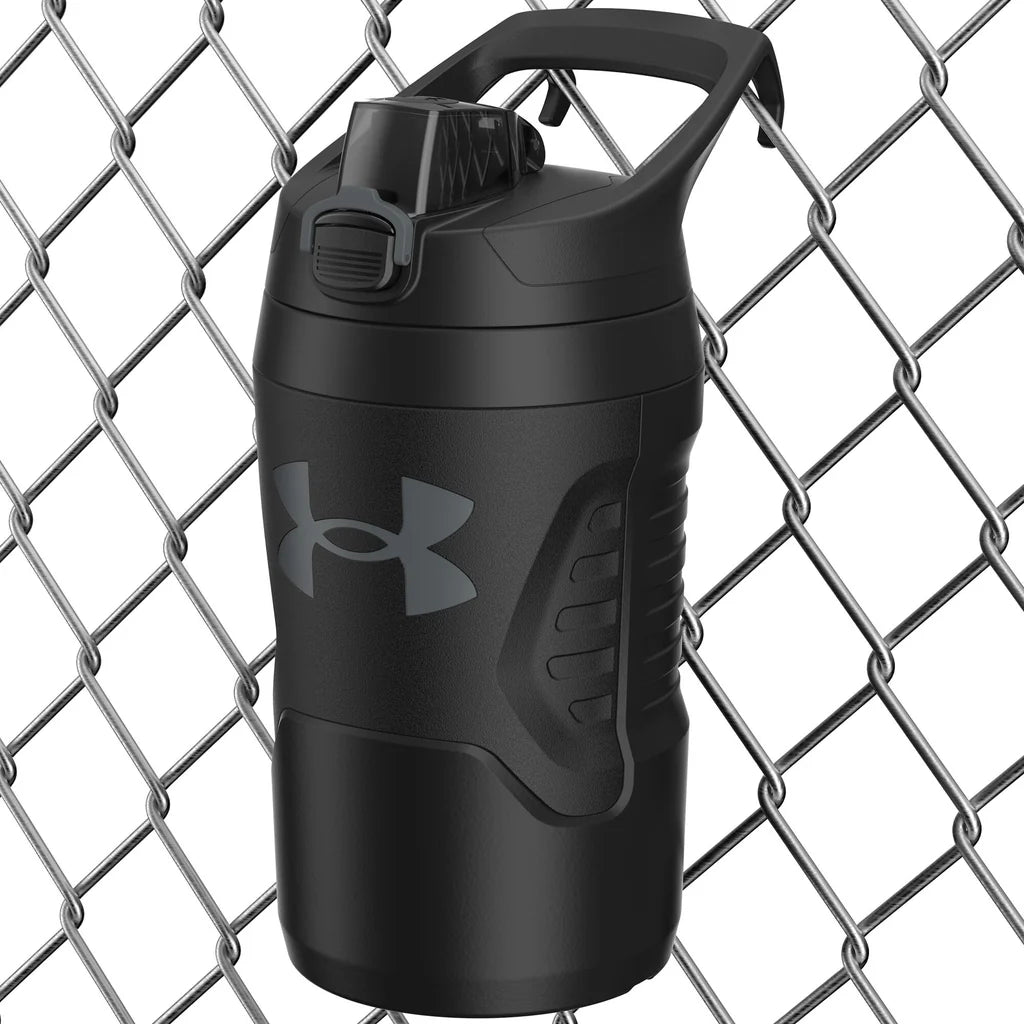 Black Under Armour shaker bottle against a chain-link fence background