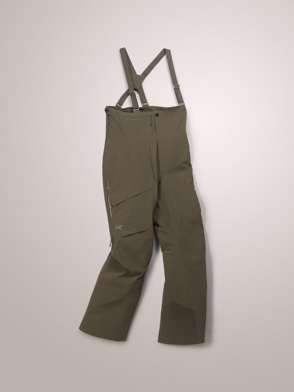 Green bib overalls with suspenders on a light gray background