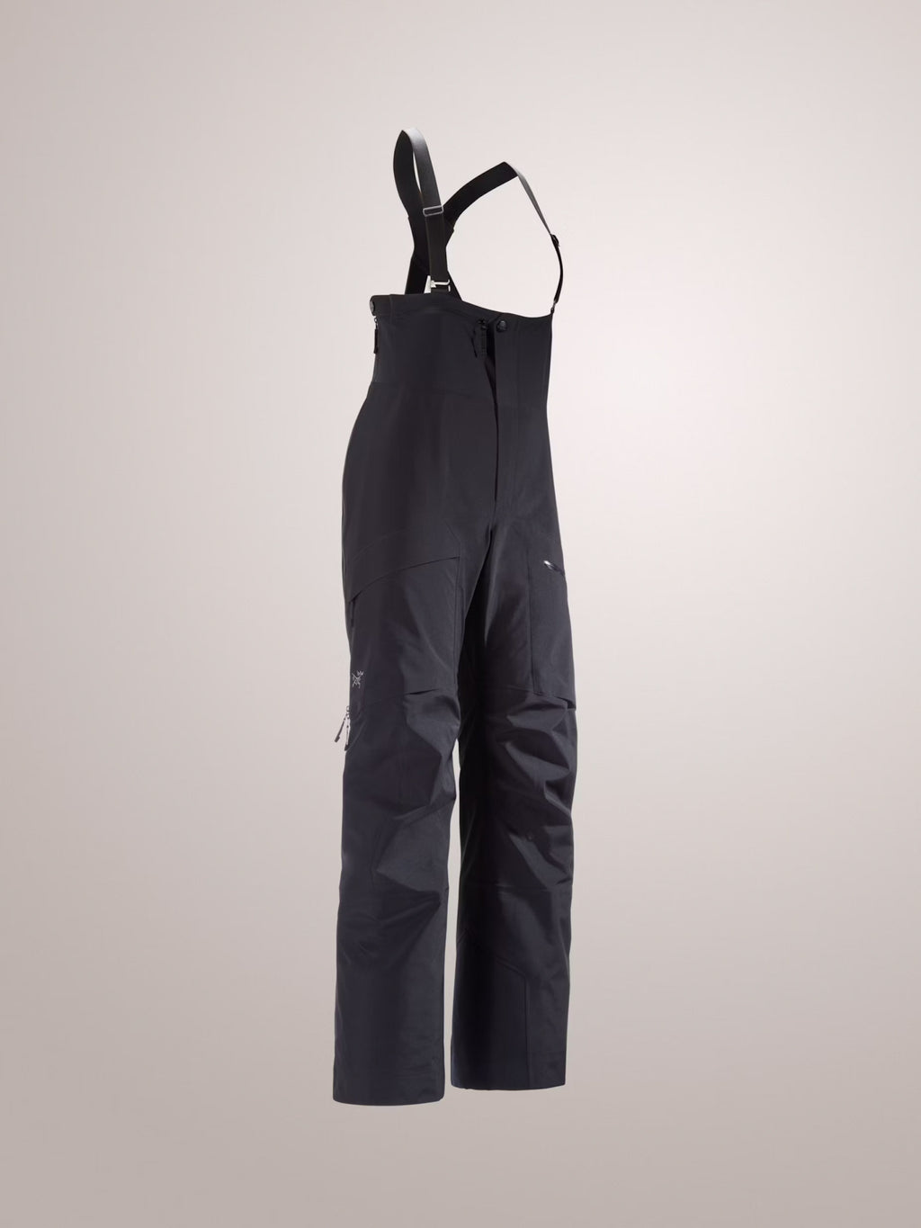 Black bib overalls on a light gray background