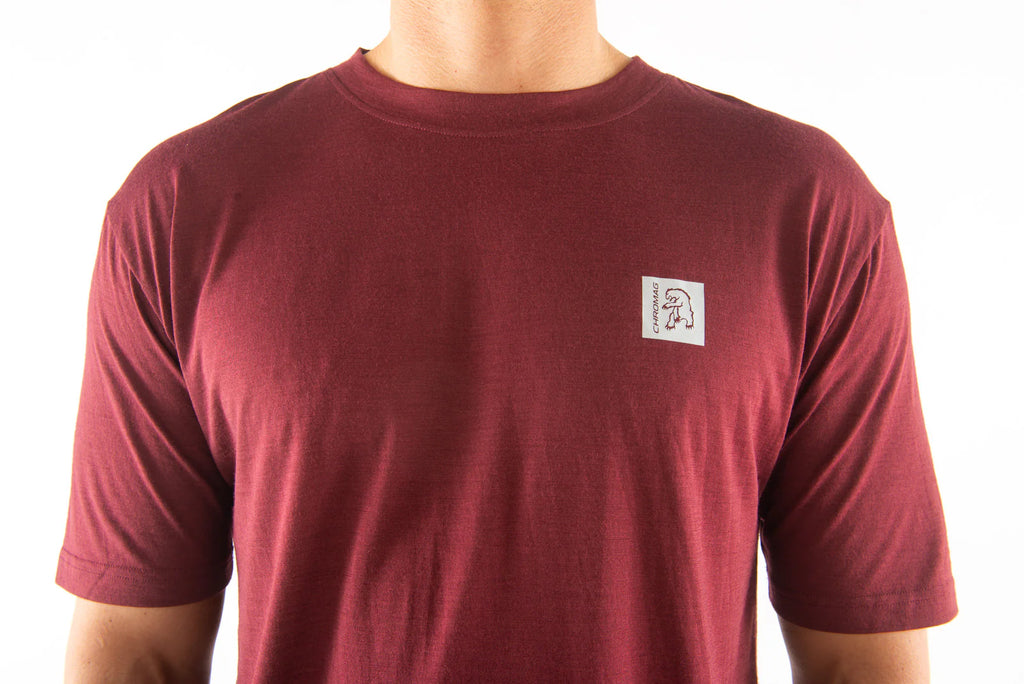 Maroon t-shirt with a small logo on the chest against a white background