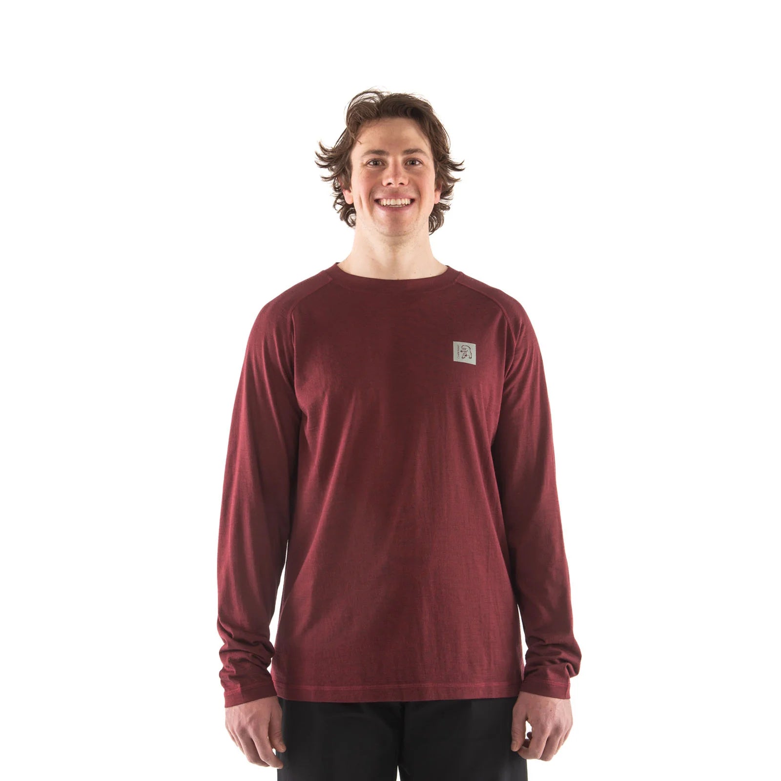 Person wearing a maroon long-sleeve shirt with a small logo on a white background