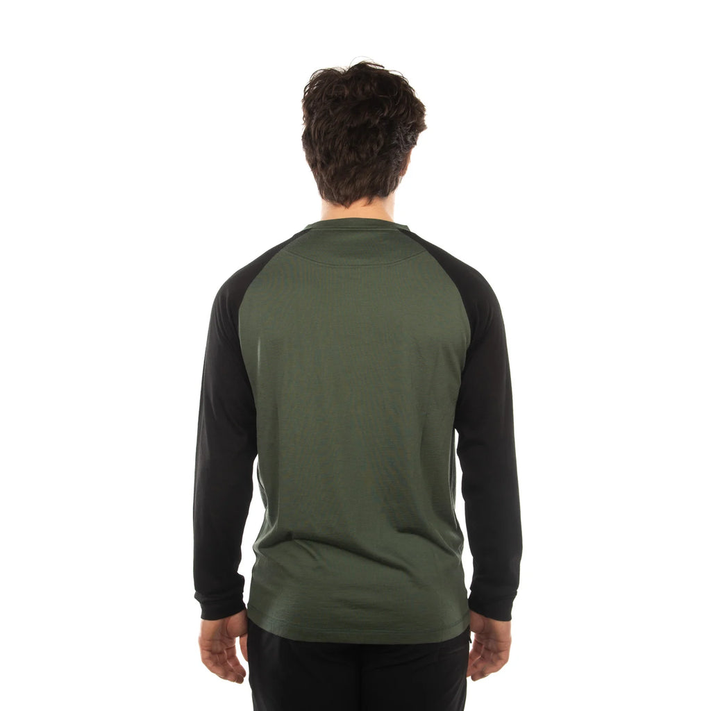 A man viewed from behind wearing a long-sleeve raglan shirt with an olive green body and black sleeves, set against a plain white background.