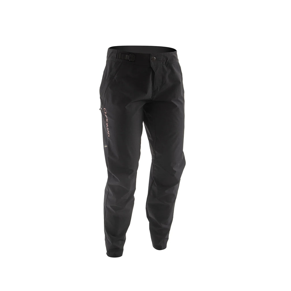 Black technical riding pants with a zippered side pocket and a vertical white 'Chromag' brand logo on the left leg, shown against a plain white background.