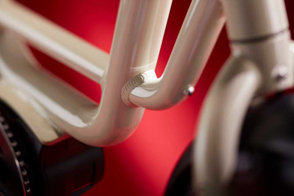 Close-up of a bicycle frame with a red background