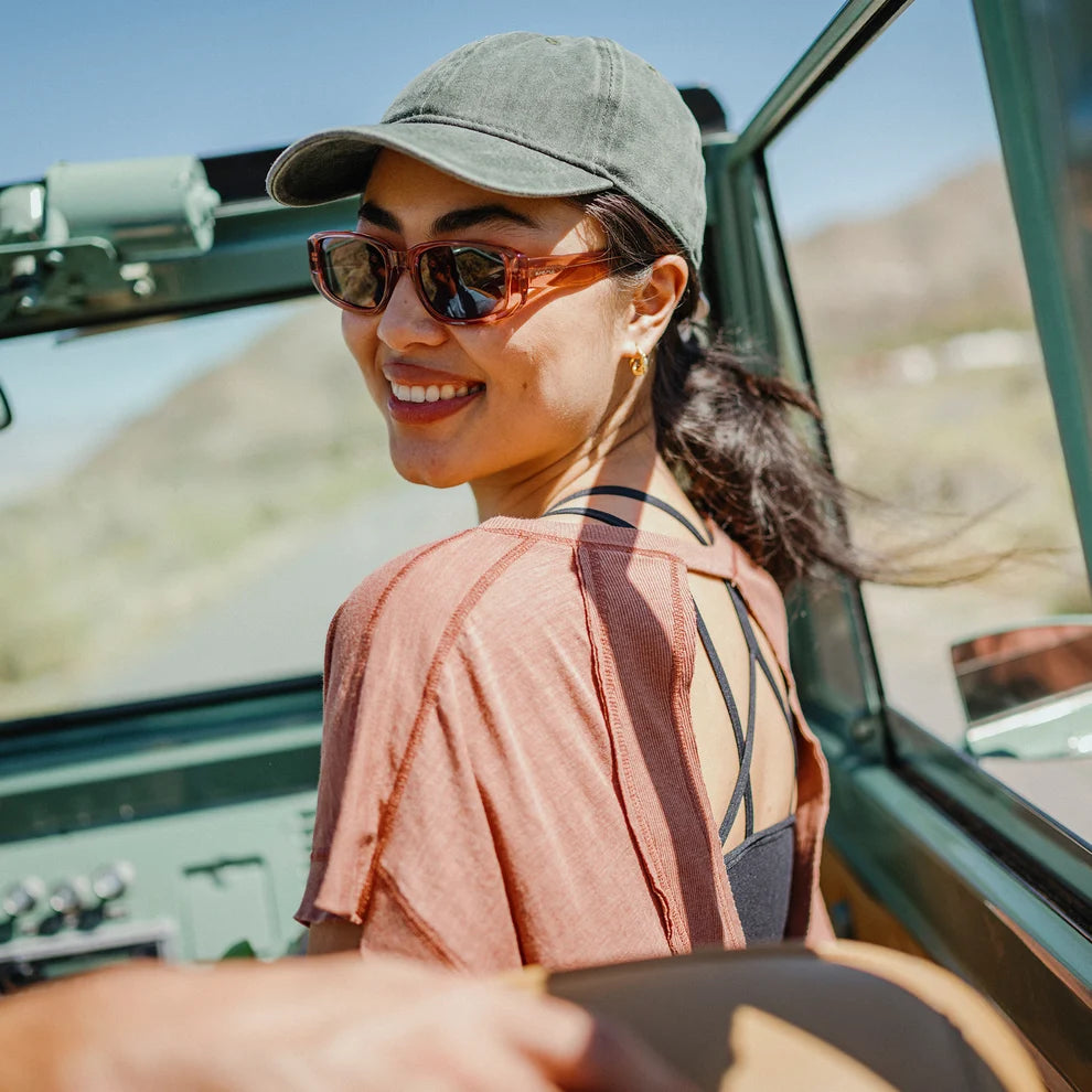 Woman driving a vehicle with a scenic background