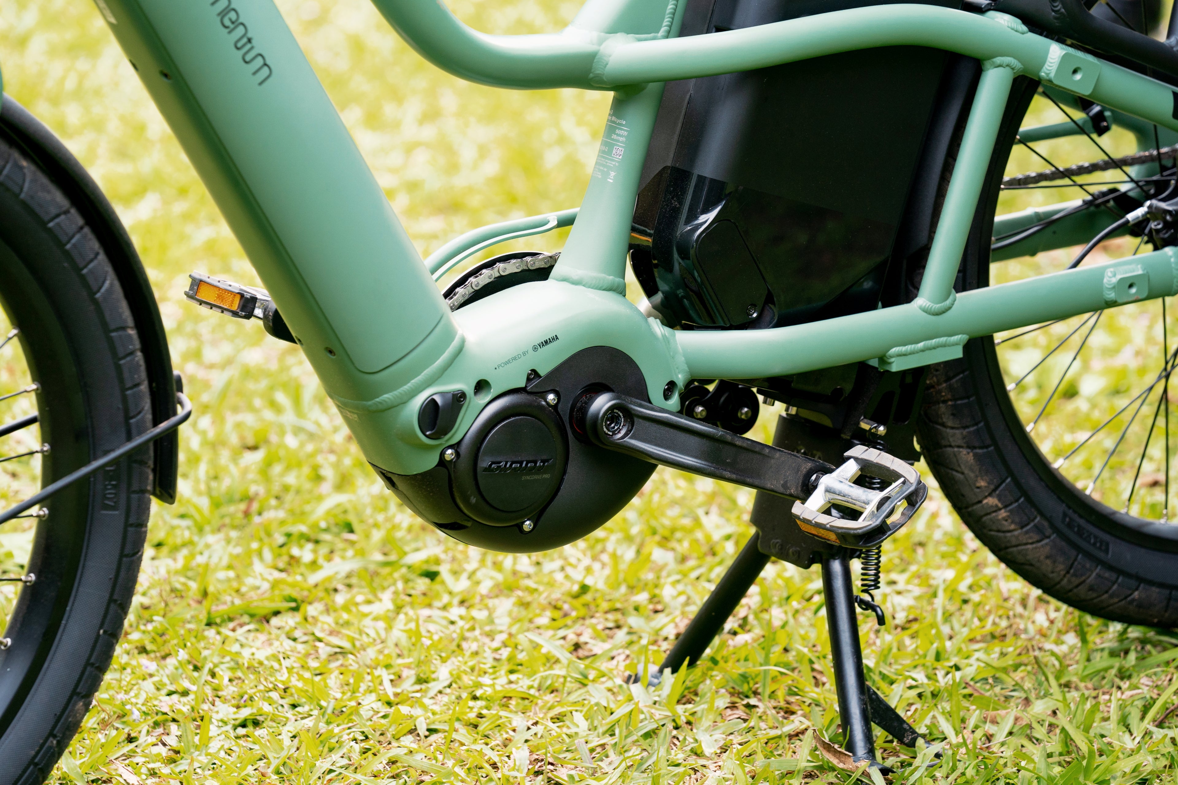 Close-up of a green electric bike on grass