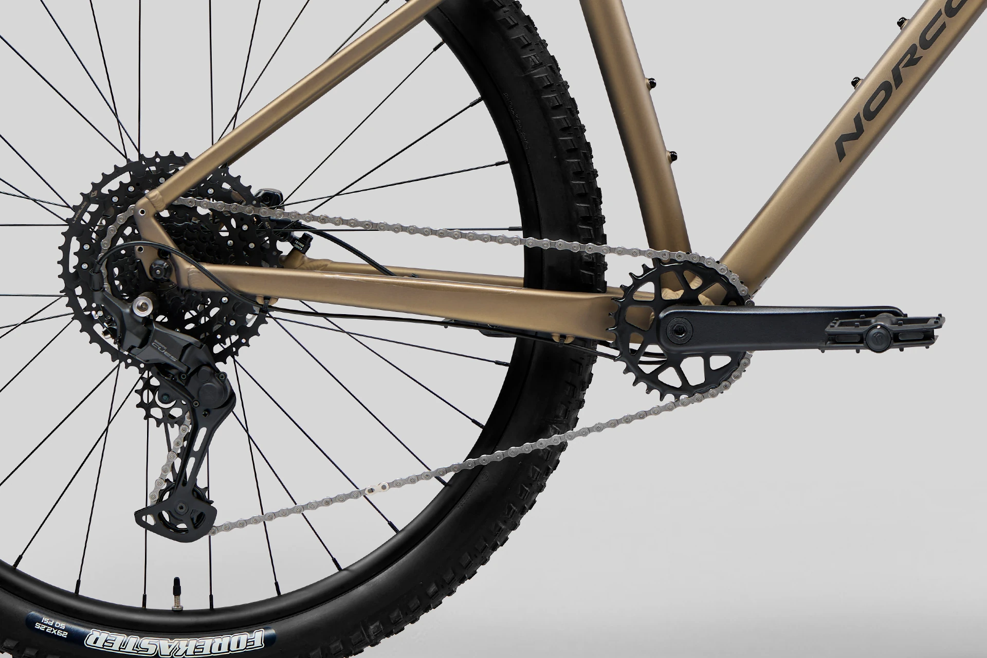 Close-up of a bicycle's rear wheel and gear system on a gray background