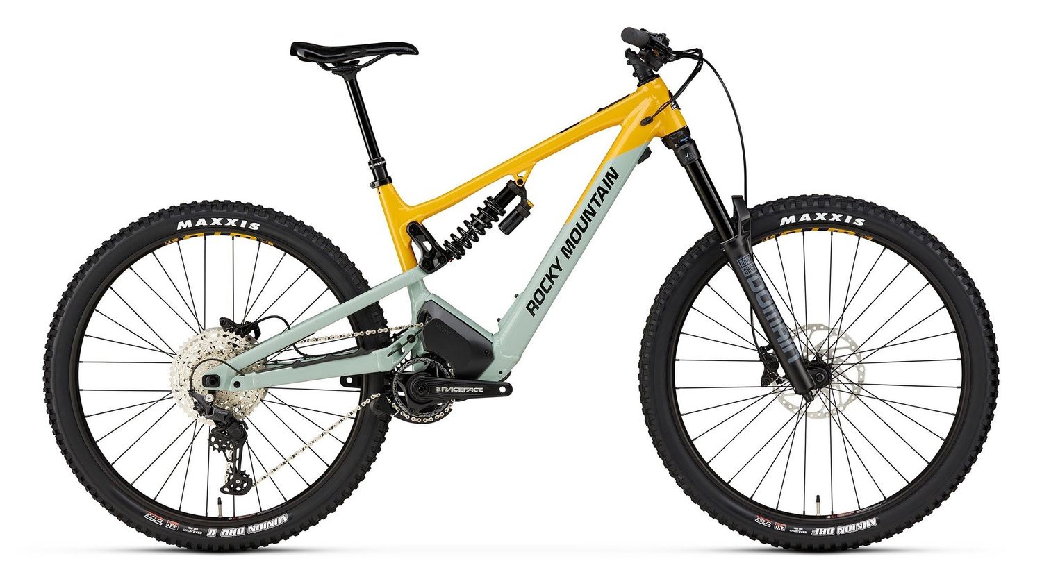Yellow and gray mountain bike with 'Rock Machine' branding on a white background