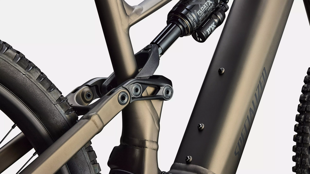Close-up of a mountain bike's suspension fork and chainstay on a white background