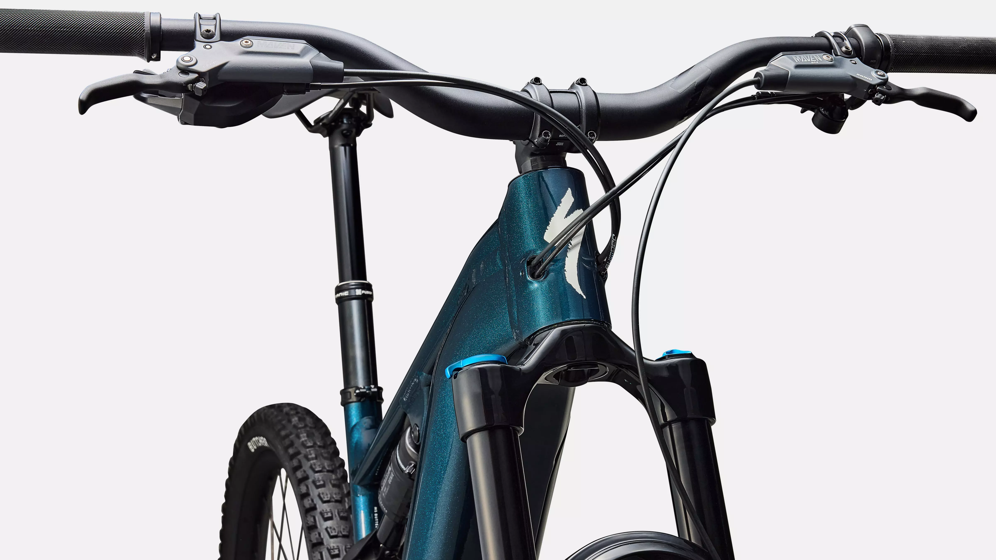 Close-up of a blue electric bike with black handlebars on a white background