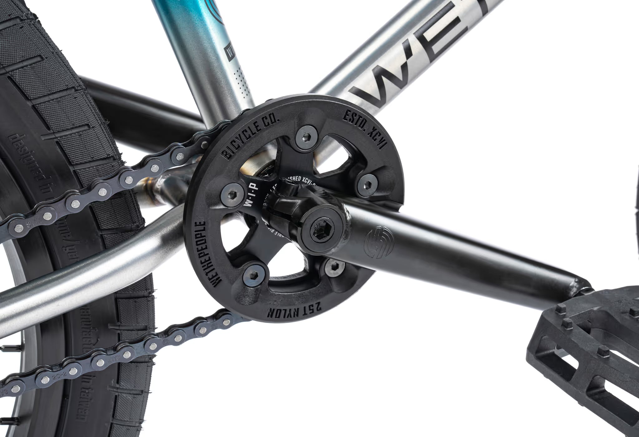 Close-up of a bicycle chain and gear system with 'Wethepeople' branding