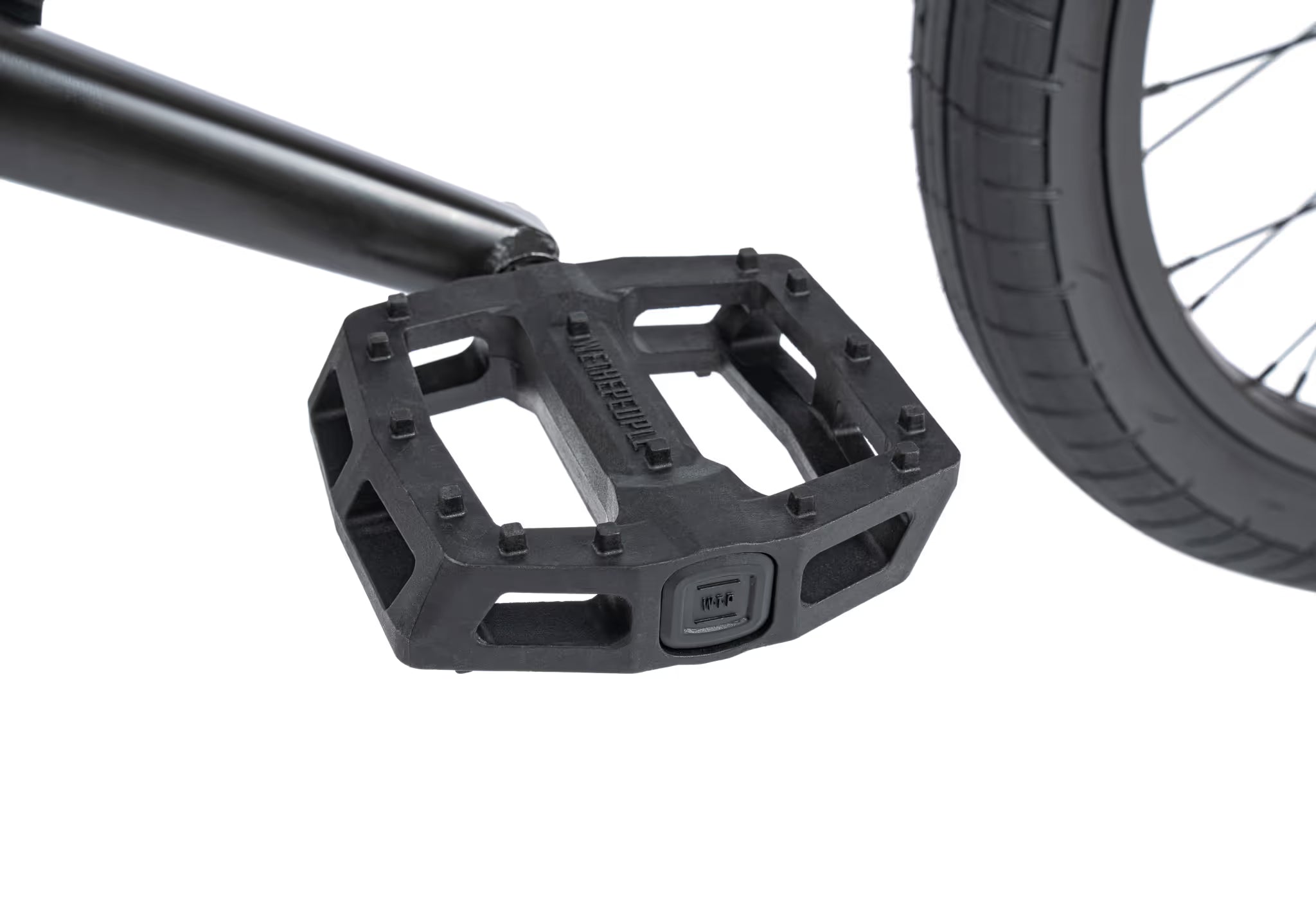 Close-up of a black bicycle pedal with a white background