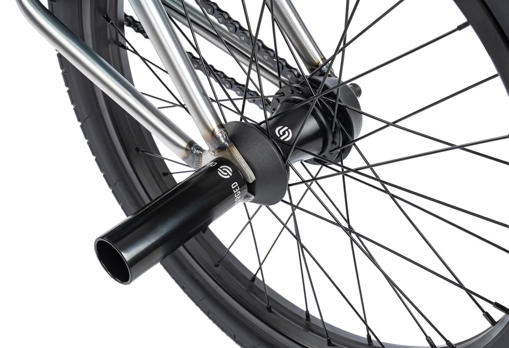 Close-up of a bicycle wheel with a black hub and silver spokes on a white background