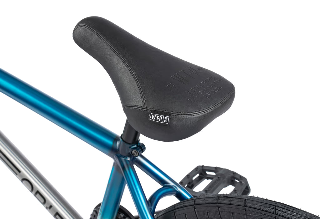 Close-up of a bicycle seat with blue frame and black seat on a white background