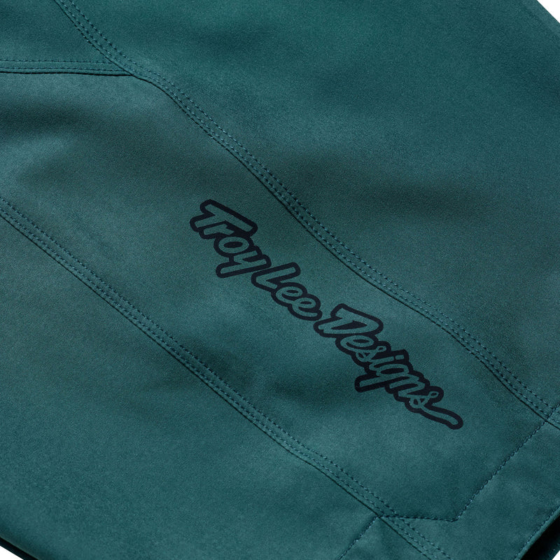 Teal fabric with 'Troy Lee Designs' logo embroidered on it