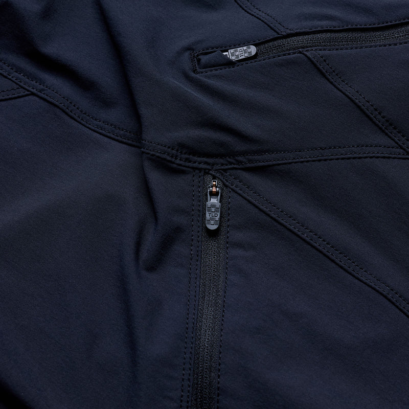 Close-up of a navy blue jacket with zippers and buttons.